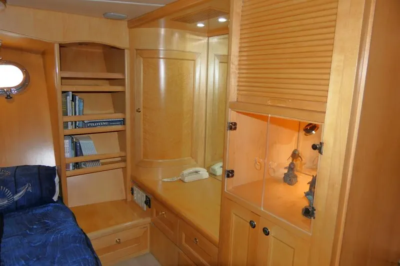 Slide: The Image of Interior of 1999 Hampton 490 Pilothouse with wooden cabinetry and cozy sleeping area. - 30