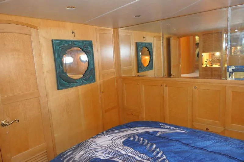 Slide: The Image of Luxurious cabin interior of 1999 Hampton 490 Pilothouse yacht with wood paneling and nautical decor. - 31
