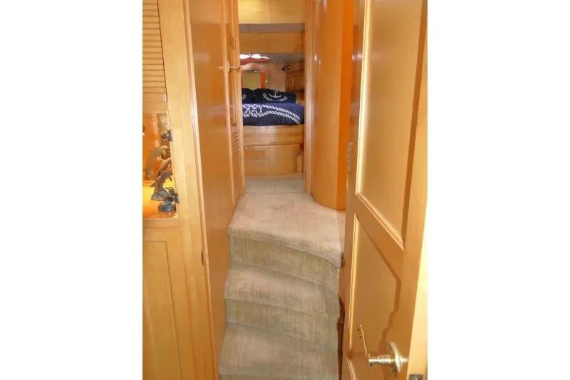Slide: The Image of Interior view of 1999 Hampton 490 Pilothouse yacht with carpeted stairs and wooden cabinetry. - 35