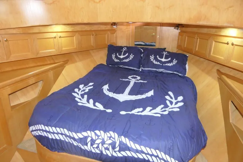 Slide: The Image of Cozy cabin bedroom in 1999 Hampton 490 Pilothouse with nautical-themed bedding. - 36