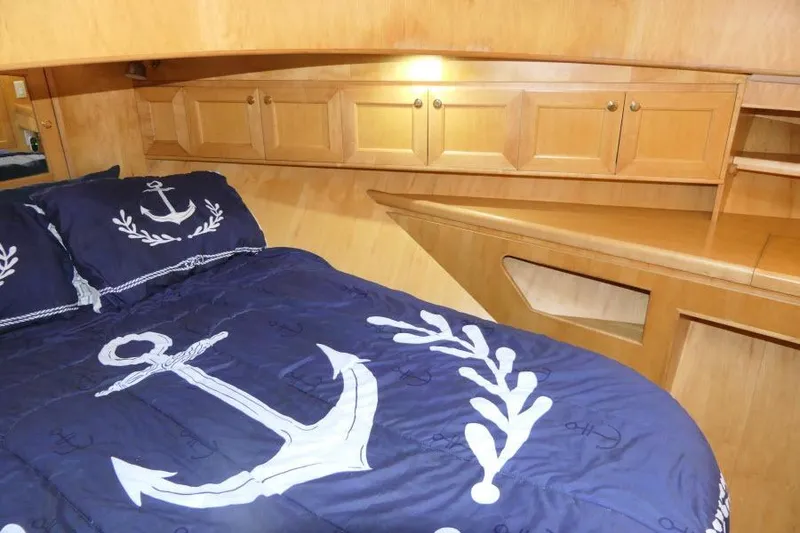 Slide: The Image of Cozy cabin interior of 1999 Hampton 490 Pilothouse with nautical-themed bedding. - 38