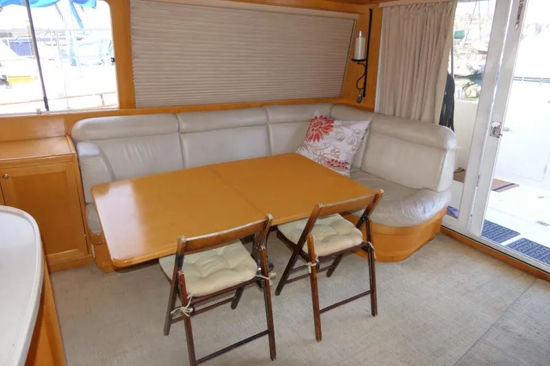 Slide: The Image of Interior of 1999 Hampton 490 Pilothouse with dining area and seating. - 4