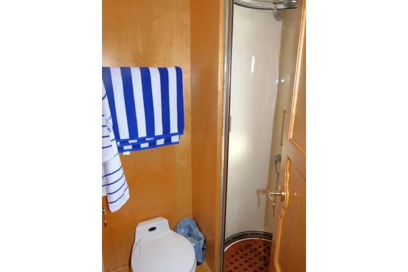 Slide: The Image of Bathroom interior of 1999 Hampton 490 Pilothouse with shower and striped towel. - 41