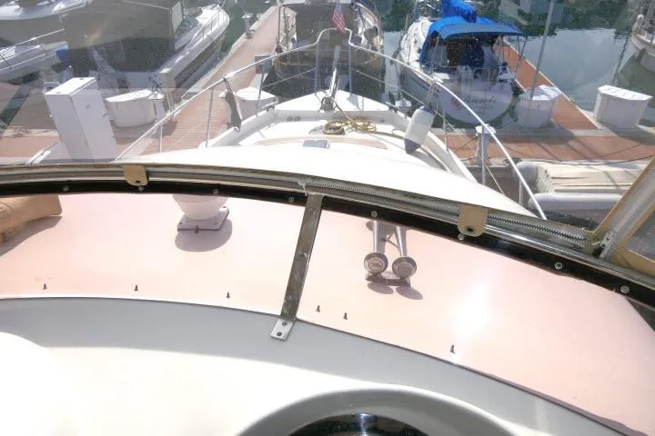 Slide: The Image of 1999 Hampton 490 Pilothouse yacht docked at marina, view from helm. - 51