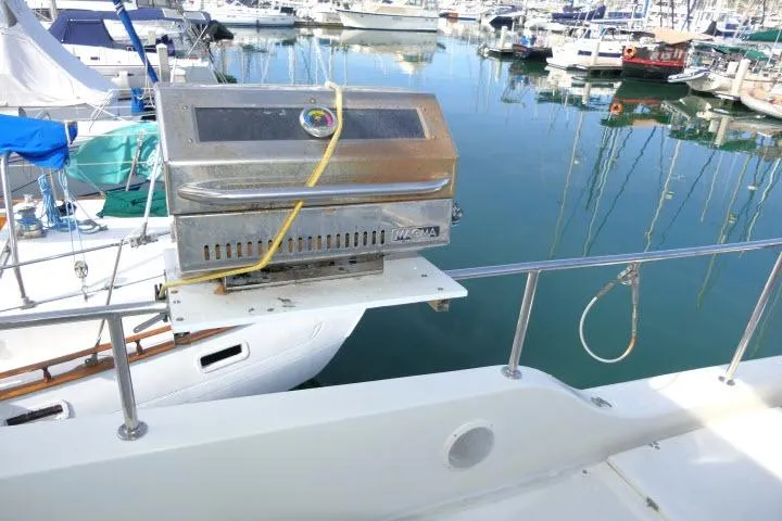 Slide: The Image of Outdoor grill on a 1999 Hampton 490 Pilothouse yacht, docked in a marina. - 61