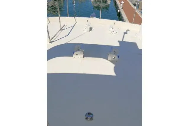 Slide: The Image of Bow deck of a 1999 Hampton 490 Pilothouse yacht, docked at a marina. - 63
