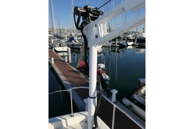 Slide: The Image of 1999 Hampton 490 Pilothouse yacht docked at marina with sailboats. - 68