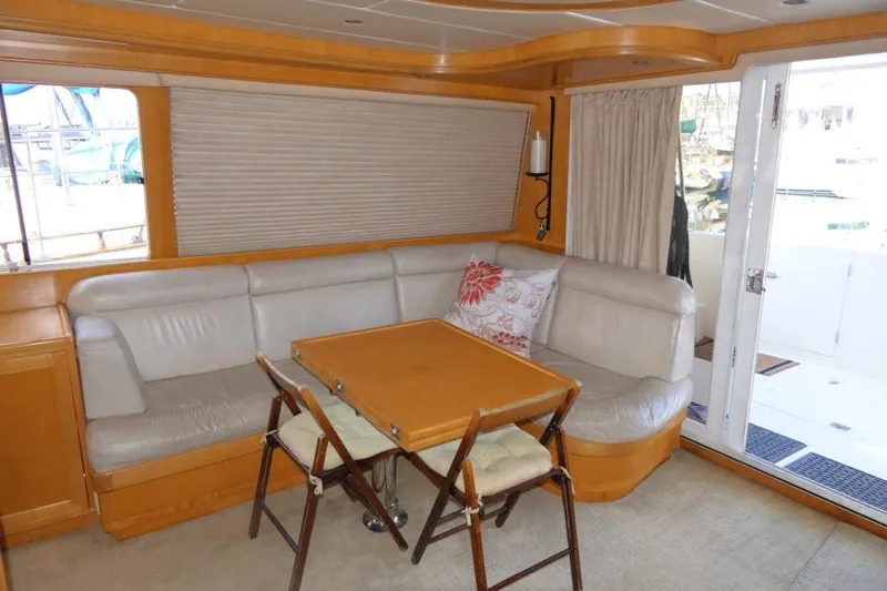 Slide: The Image of Interior of 1999 Hampton 490 Pilothouse with leather seating and foldable table. - 7