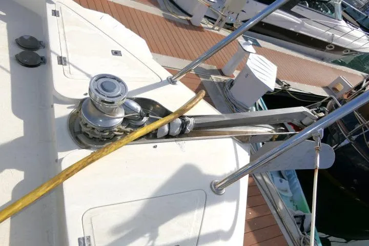 Slide: The Image of Bow of 1999 Hampton 490 Pilothouse yacht with anchor winch and rope. - 70