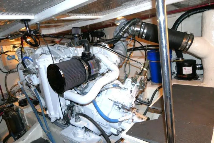 Slide: The Image of Engine room of a 1999 Hampton 490 Pilothouse yacht, showcasing mechanical components. - 78