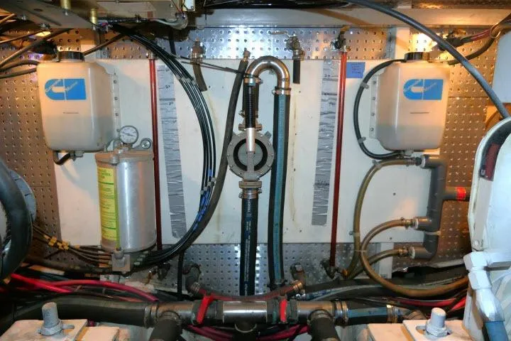 Slide: The Image of Engine room of a 1999 Hampton 490 Pilothouse with various mechanical components. - 80