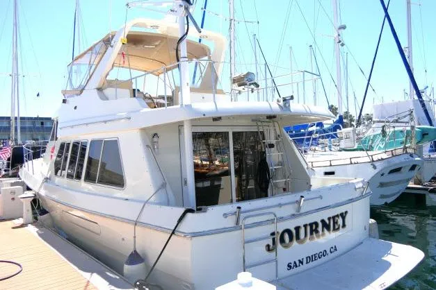 Slide: The Image of 1999 Hampton 490 Pilothouse yacht docked in San Diego marina. - 85