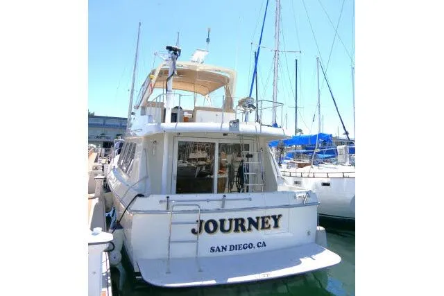Slide: The Image of 1999 Hampton 490 Pilothouse yacht named "Journey" docked in San Diego marina. - 86