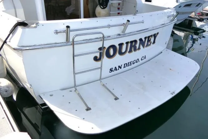 Slide: The Image of Stern view of 1999 Hampton 490 Pilothouse boat named "Journey" in San Diego marina. - 87