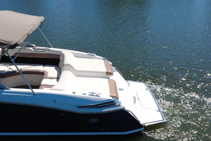 Slide: The Image of 2012 Cobalt 296 boat with cushioned seating on calm water. - 11