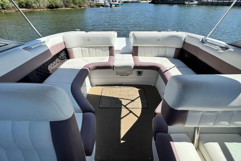 Slide: The Image of Luxurious seating area on a 2012 Cobalt 296 boat, overlooking serene waters. - 13