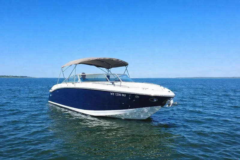 Slide: The Image of 2012 Cobalt 296 boat on calm blue water under clear sky. - 2