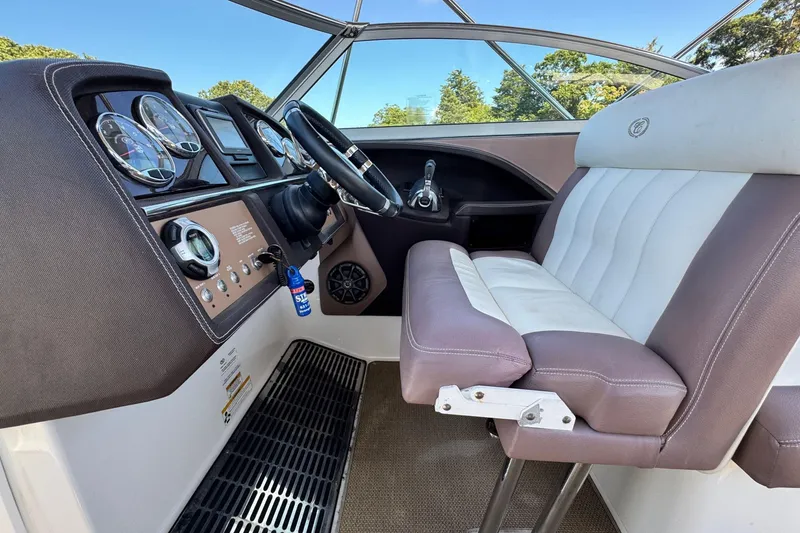 Slide: The Image of Interior of a 2012 Cobalt 296 boat, featuring a sleek dashboard and comfortable seating. - 24