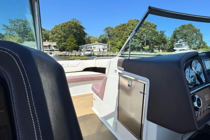 Slide: The Image of Interior view of a 2012 Cobalt 296 boat with dashboard and seating. - 27