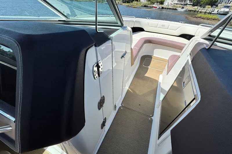 Slide: The Image of Interior view of a 2012 Cobalt 296 boat, featuring seating and storage compartments. - 28