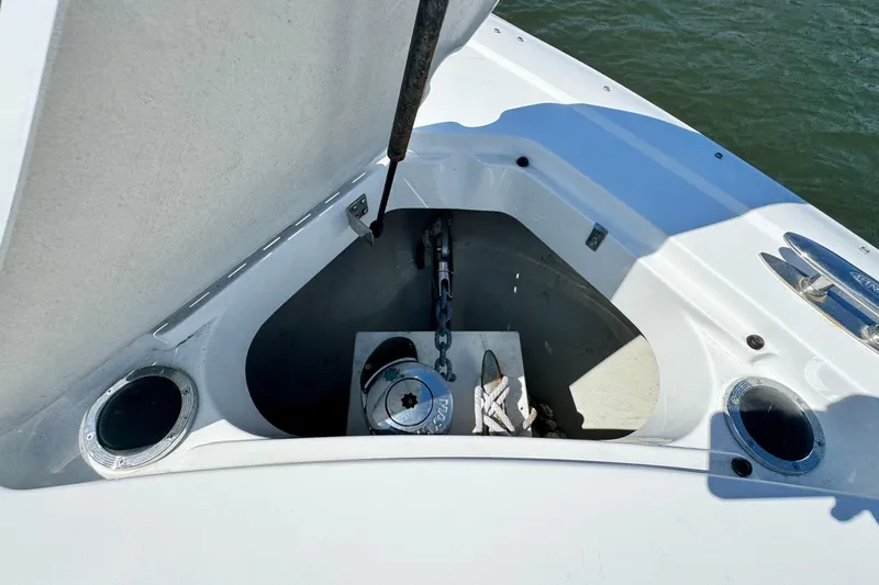 Slide: The Image of Anchor compartment of a 2012 Cobalt 296 boat with visible chain and rope. - 32
