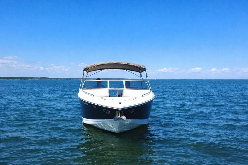 Slide: The Image of 2012 Cobalt 296 boat on open water under clear blue sky. - 8