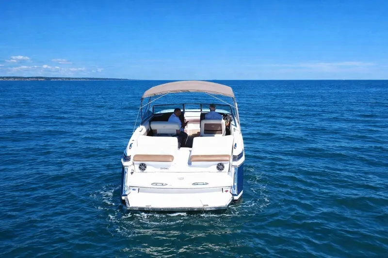Slide: The Image of 2012 Cobalt 296 boat cruising on open blue water under clear skies. - 9
