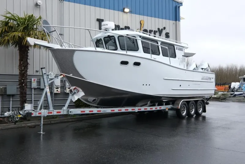 The Image of 2026 Hewescraft 290 Adventure ET Hardtop boat on a trailer outside a dealership. - 1