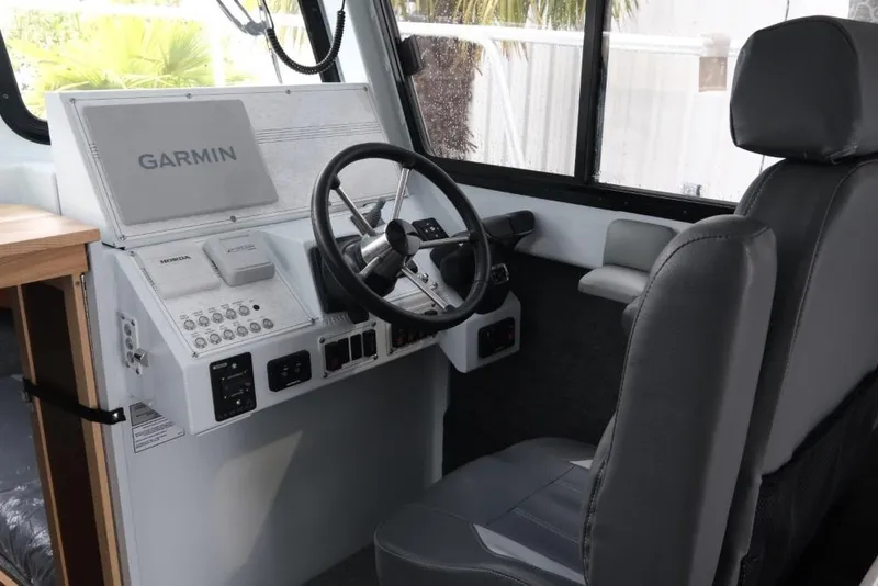 Slide: The Image of Interior helm of 2026 Hewescraft 290 Adventure ET Hardtop with Garmin navigation system. - 12