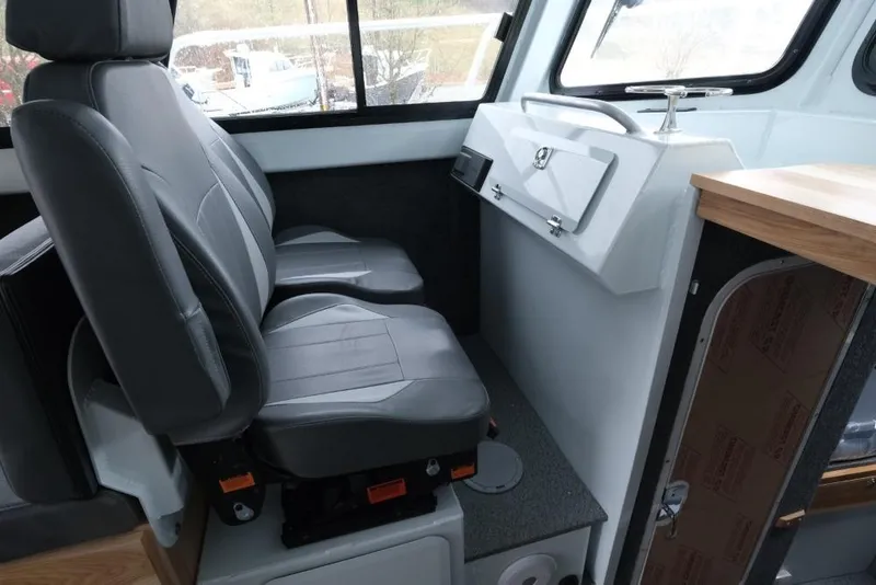 Slide: The Image of Interior of 2026 Hewescraft 290 Adventure ET Hardtop with gray seating and control panel. - 14