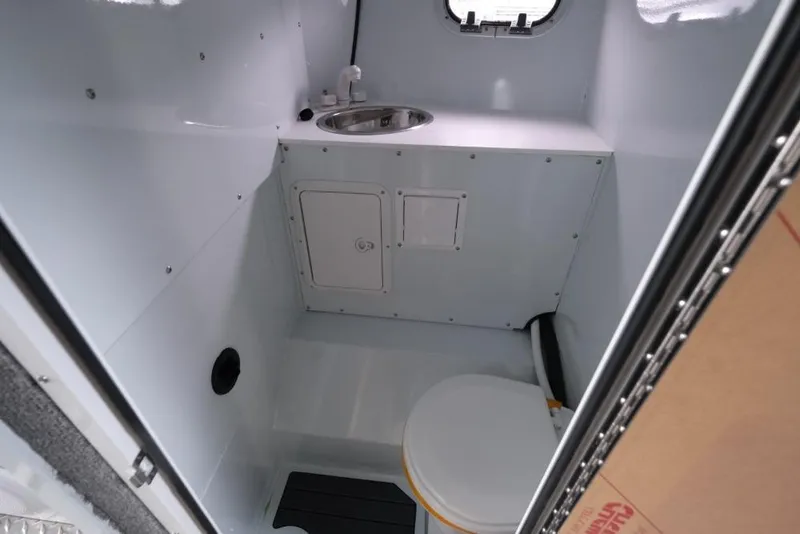 Slide: The Image of Interior of 2026 Hewescraft 290 Adventure ET Hardtop boat bathroom with sink and toilet. - 16