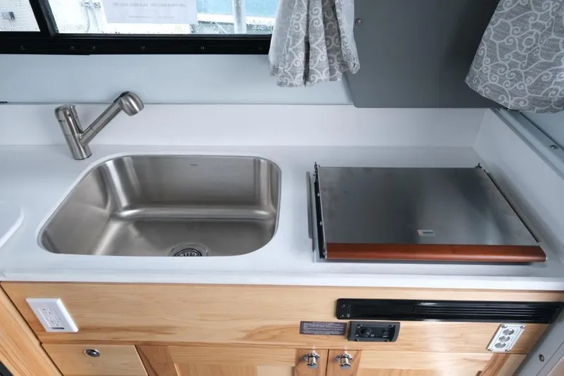 Slide: The Image of 2026 Hewescraft 290 Adventure ET Hardtop kitchen with stainless steel sink and stove. - 18