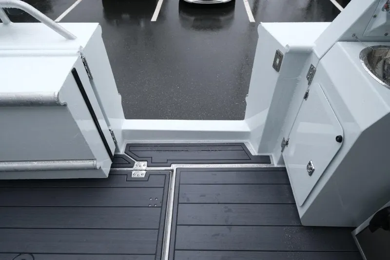 Slide: The Image of 2026 Hewescraft 290 Adventure ET Hardtop boat deck with sleek design and storage compartments. - 21