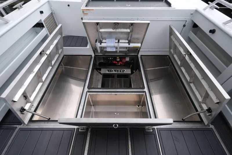 Slide: The Image of Open storage compartments on 2026 Hewescraft 290 Adventure ET Hardtop boat deck. - 24