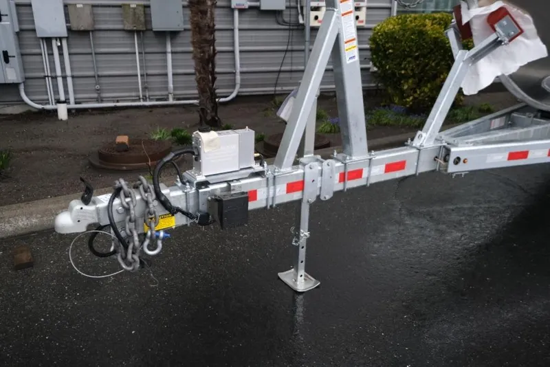 Slide: The Image of Trailer hitch of 2026 Hewescraft 290 Adventure ET Hardtop on wet pavement. - 25