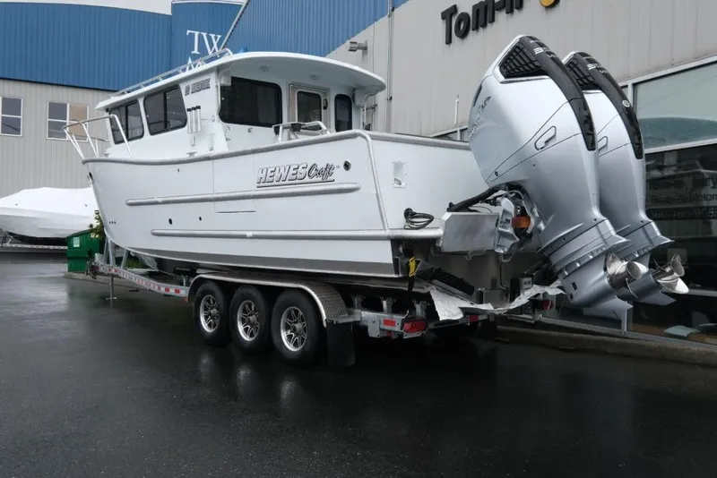 Slide: The Image of 2026 Hewescraft 290 Adventure ET Hardtop boat with dual outboard motors on a trailer. - 4