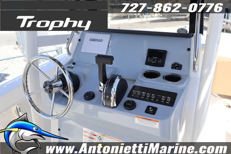 Slide: The Image of 2026 Bayliner Trophy T20CC boat dashboard with steering wheel and controls. - 8