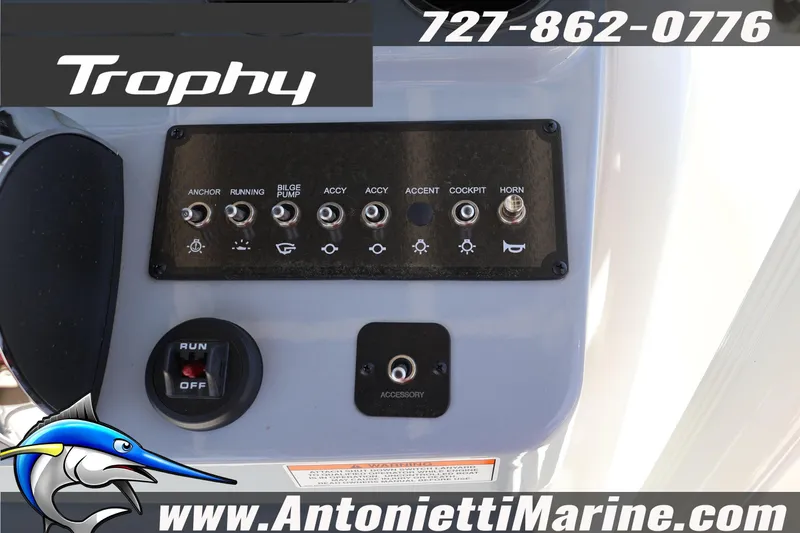 Slide: The Image of Control panel of 2026 Bayliner Trophy T20CC boat with switches and branding. - 9