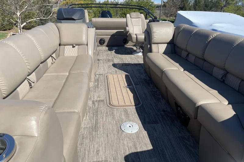 Slide: The Image of 2024 Ranger 2500LS boat interior with beige seating and spacious layout. - 10