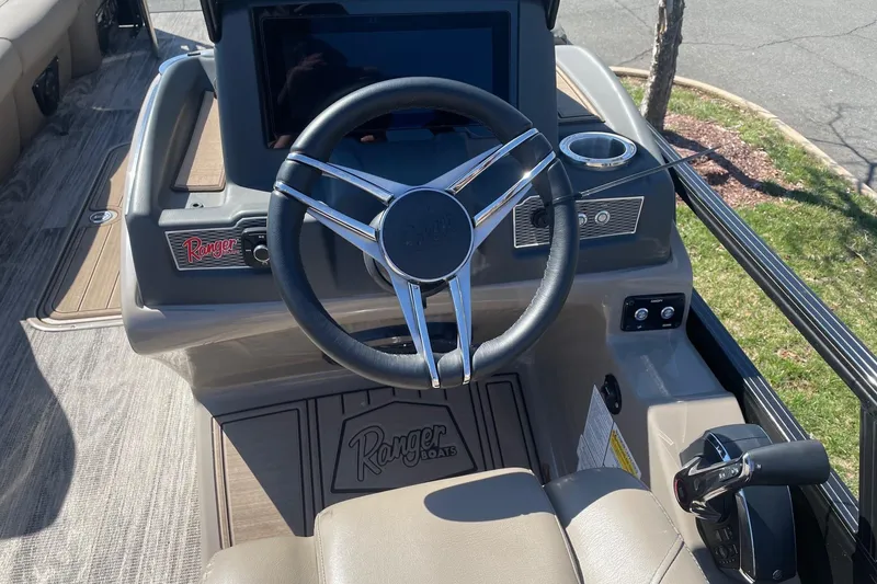 Slide: The Image of 2024 Ranger 2500LS boat dashboard with steering wheel and control panel. - 13