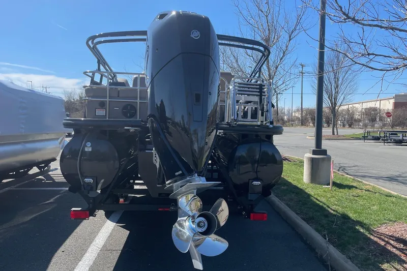 Slide: The Image of 2024 Ranger 2500LS boat with powerful outboard motor in a parking lot. - 7