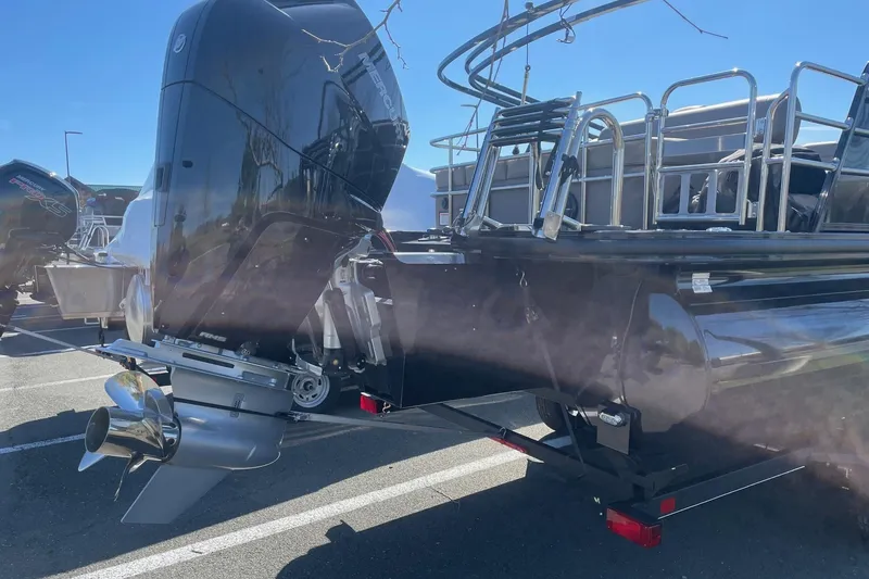 Slide: The Image of 2024 Ranger 2500LS boat with powerful outboard motor in a sunny parking lot. - 9