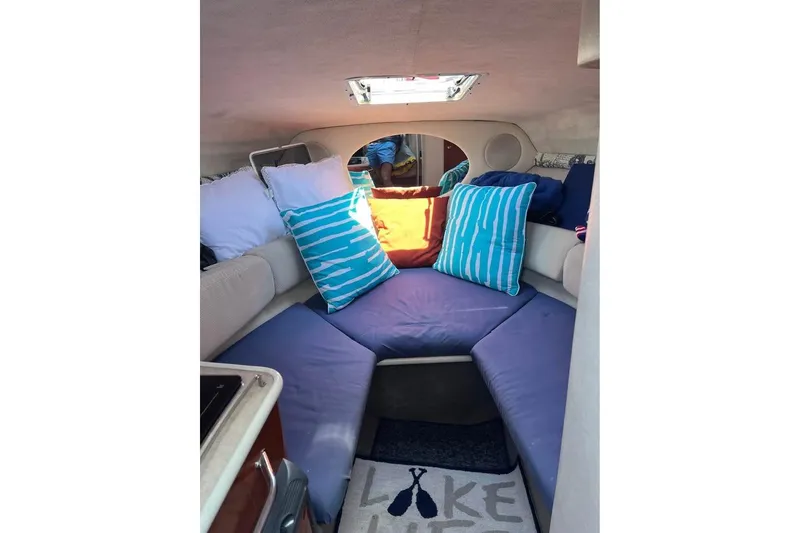 Slide: The Image of Interior of 2004 Sea Ray 240 Sundancer with colorful cushions and cozy seating. - 12