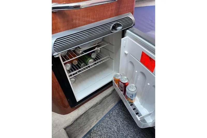 Slide: The Image of Mini fridge stocked with beverages inside a 2004 Sea Ray 240 Sundancer boat. - 15