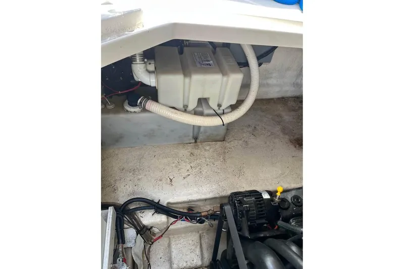 Slide: The Image of Engine compartment of a 2004 Sea Ray 240 Sundancer boat, showing mechanical components. - 20
