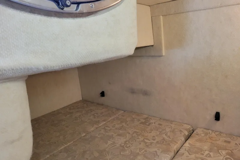 Slide: The Image of Interior cabin of 2004 Sea Ray 240 Sundancer with beige upholstery. - 27