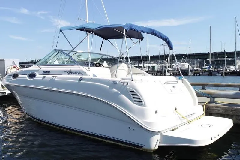 Slide: The Image of 2004 Sea Ray 240 Sundancer boat docked at marina with blue canopy. - 5
