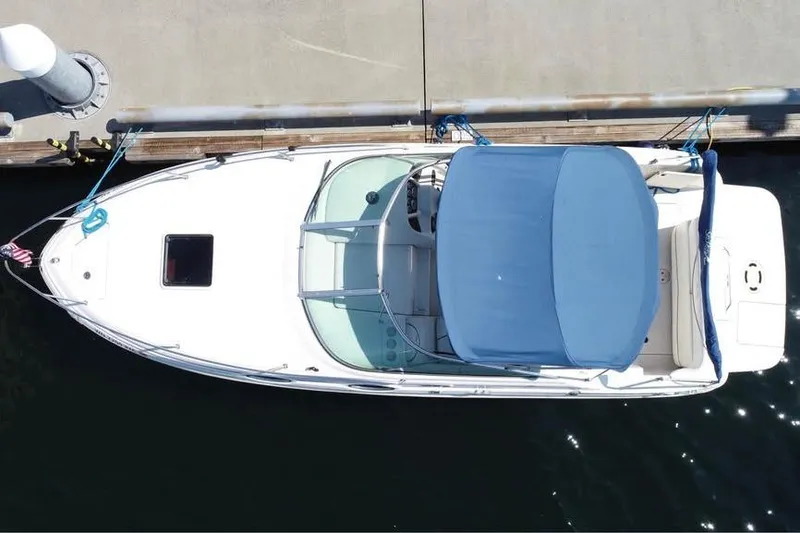 Slide: The Image of Overhead view of 2004 Sea Ray 240 Sundancer docked with blue canopy. - 6