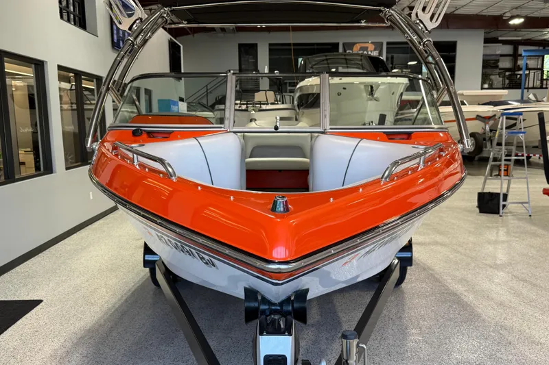 Slide: The Image of 2005 Calabria PRO V boat with orange and white design in showroom. - 1