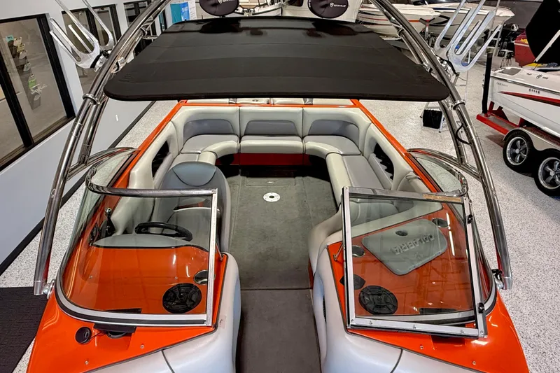 Slide: The Image of 2005 Calabria PRO V boat interior with orange accents and seating arrangement. - 12